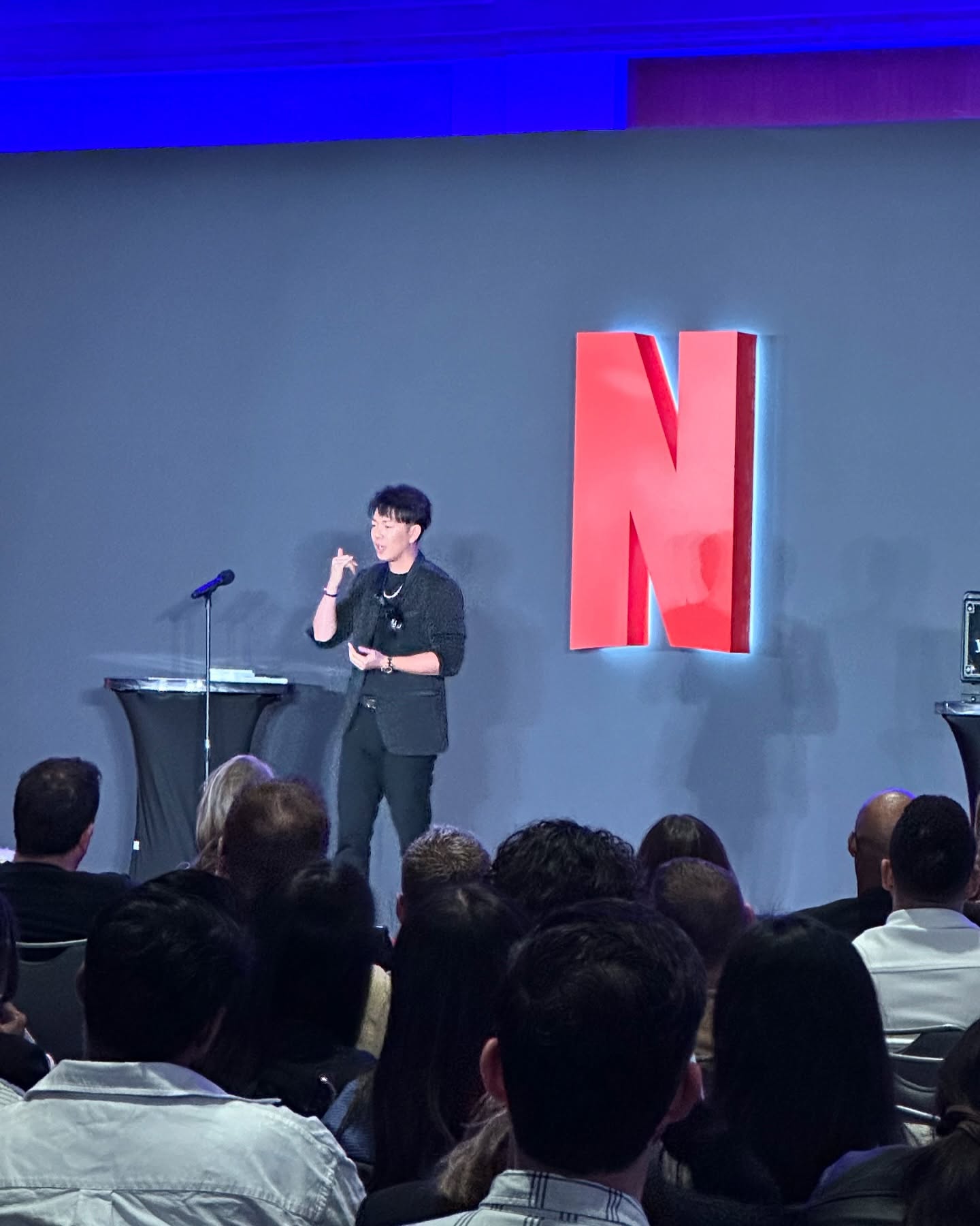 Johnny Wu performing on stage at a Netflix keynote